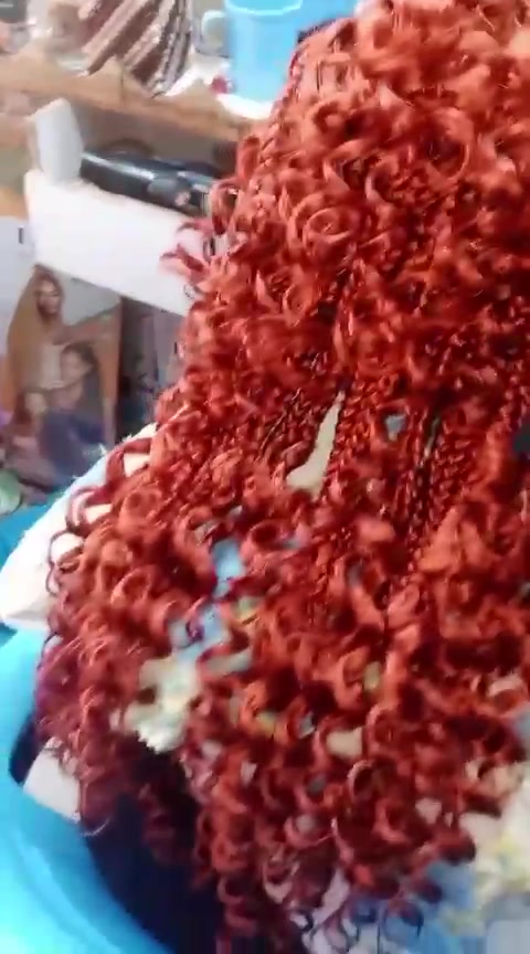 Red curly crochet braid texture detail